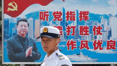 A soldier in front of an image of Chinese President Xi Jinping in Hong Kong, June 2019