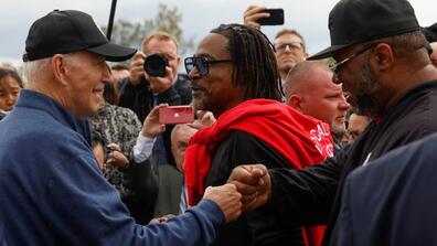President Joe Biden greets people as he joins striking members of the United Auto Workers on the picket line outside the GM Willow Run Distribution Center in Michigan on September 26, 2023.