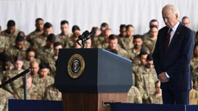 President Joe Biden bows his head during remarks to service members, first responds and their families at Joint Base Elmendorf-Richardson in Anchorage, Alaska, on the 22nd anniversary of the 9/11 terrorist attacks on New York and Washington.