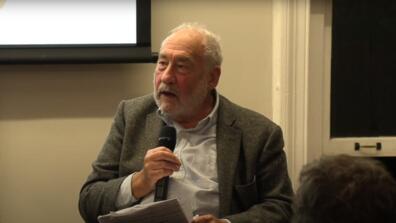 Joseph Stiglitz speaks at a 2023 conference on industrial policy -- here he is holding a hand microphone..