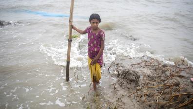 Young Bengali girl in polluted oceanside