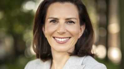 keren yarhi-milo smiling and wearing a light gray blazer
