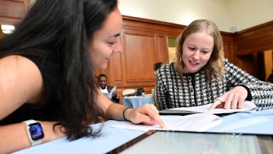 A photo of two students studying a problem set in a Columbia library.