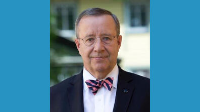 Toomas Ilves wears round eyeglasses and a striped bowtie.