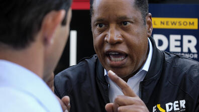 Radio show host Larry Elder argues with a TV reporter in an interview