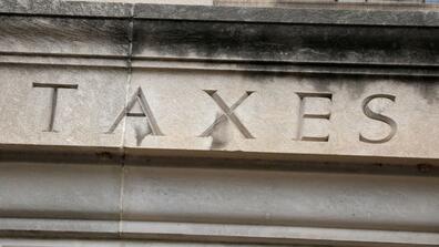 The word “taxes” is seen engraved at the headquarters of the Internal Revenue Service (IRS) in Washington, D.C.