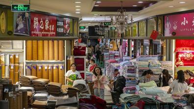 Vendors wait for customers at fabric stores in Chongqing, China