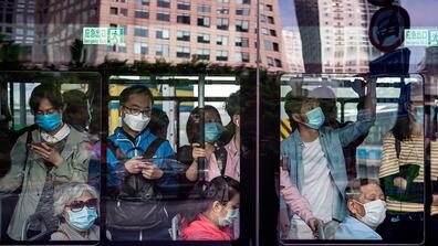 People inside a public transportation bus in China