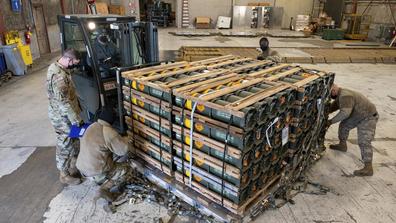 In this image provided by the U.S. Air Force, Airmen and civilians from the 436th Aerial Port Squadron palletize ammunition, weapons and other equipment bound for Ukraine during a foreign military sales mission at Dover Air Force Base.