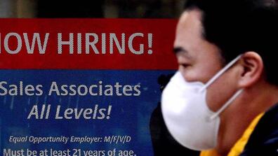 A hiring ad for sales associates with a man wearing a mask next to it
