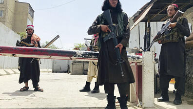 Taliban stand guard at a checkpoint near the U.S. Embassy in Kabul, Afghanistan.