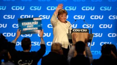 Angela Merkel waves to a crowd of supporters