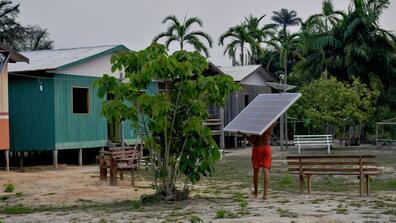 Solar panels are carried to the village of Volta do Bucho in the Western Amazon region of Brazil