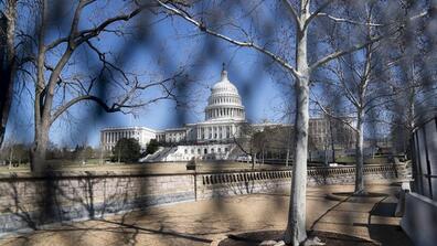 Photo taken on Feb. 28, 2022 shows the U.S. Capitol building, seen through a barrier fence, in Washington, D.C., the United States.