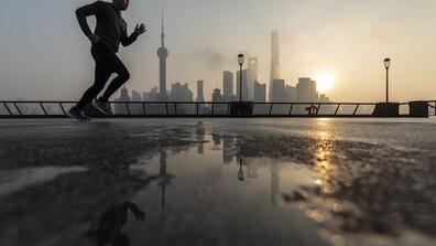 A jogger in the Lujiazui Financial District at sunrise in Shanghai in January 2022