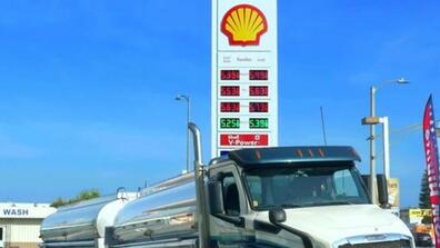 A photo showing the gas prices sign in front of a Shell gas station