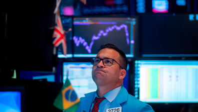 Traders react after the closing bell at the New York Stock Exchange (NYSE) on August 5. 
