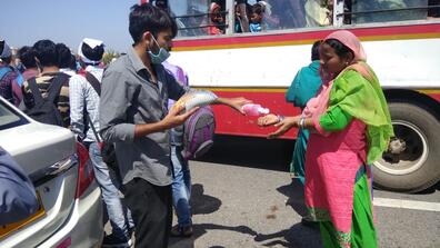 Volunteers in India distribute hand sanitizer and food to migrant workers. Photo: Muhammad Wajihulla