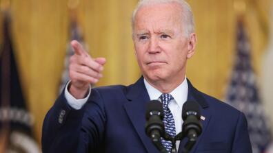 Joe Biden pointing from a podium.