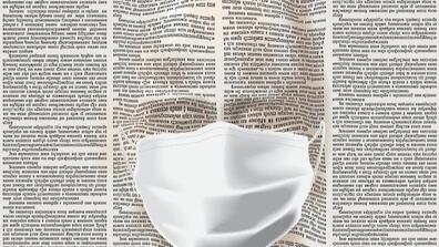 a newspaper in the form of a human face wearing a facemask