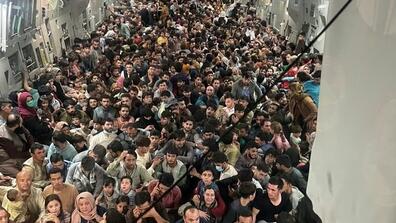 A plane leaving Afghanistan is full of people