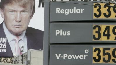 Gasoline prices are displayed on a sign at a Shell gas station as an image of Donald Trump appears on a billboard nearby April 24, 2006 in San Francisco, California.