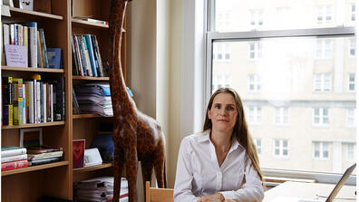 Severine Autesserre sits at a desk