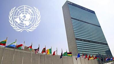 picture of flags in front of the UN