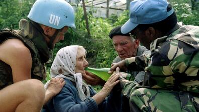 Peacekeepers providing water, Donji Potočari, Bosnia and Herzegovina, July 1995