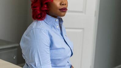 A red-haired woman poses for the camera