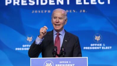 Joe Biden gives a speech at a podium