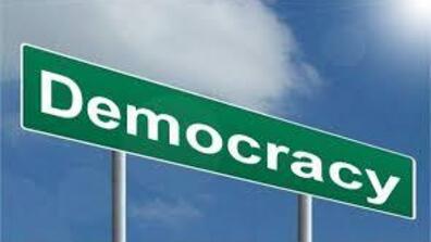 a road sign that says democracy