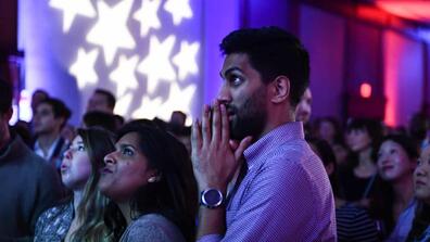 a person stands nervously waiting for election results