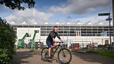 A cyclist on passes the site of the upcoming climate summit in Glasgow