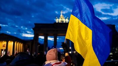 People protest in front of the Brandenburg gate against the Russian invasion of Ukraine in Berlin, Germany.