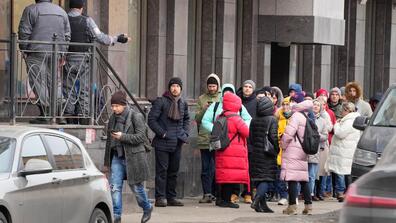 People stand in line to withdraw U.S. dollars and euros from an ATM in St. Petersburg on Feb. 25.