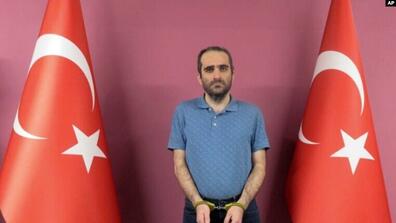 Selahattin Gülen, a nephew of U.S.-based Muslim cleric Fethullah Gülen, stands between two Turkish flags