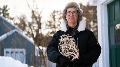 Frank Wilczek holds a clock he made