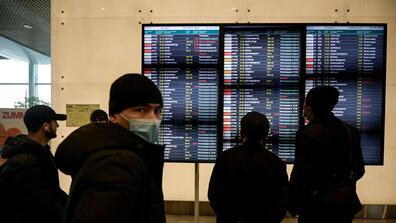 People checking the flight information at an airport