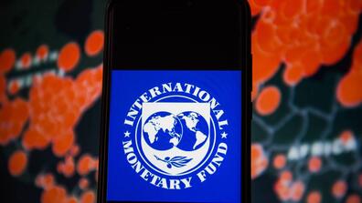 The IMF logo is displayed on a phone screen