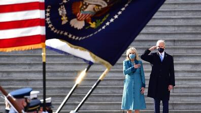 Joe and Jill Biden salute the US flag