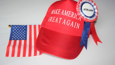 a Make America Great Again hat, Trump pin, and American flag 