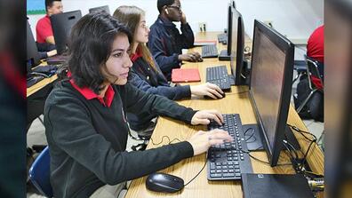Msgr. Edward Pace High student Vanessa Perez Robles, left, cracks through some coding during class. Alongside her are Pace juniors Sabina Rivero and Chrystopher Creed. 