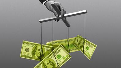 a hand controls hundred dollar bills on marionette strings