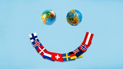 A smile formed with two globes as eyes and an arc of flags of the happiest countries in the world lined up as the mouth