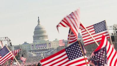 American flags wave outside the Capitol building
