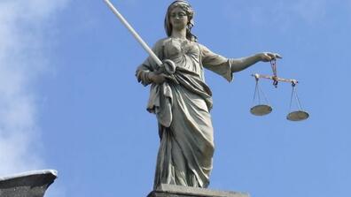 a statue depiction of Lady Justice holding scales