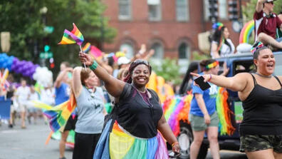 People waving rainbow flags at the Capital Pride Parade in Washington, D.C.