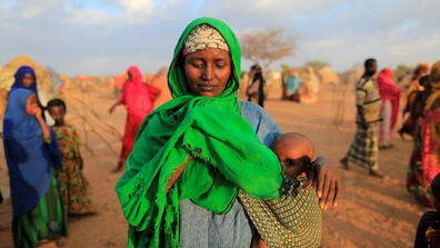 Image of an African woman with her baby in a village