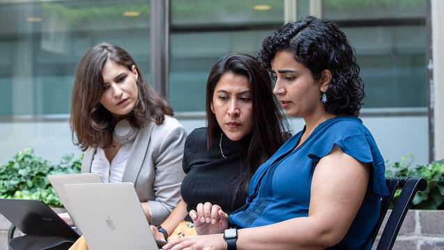 SIPA Students looking at computer screen